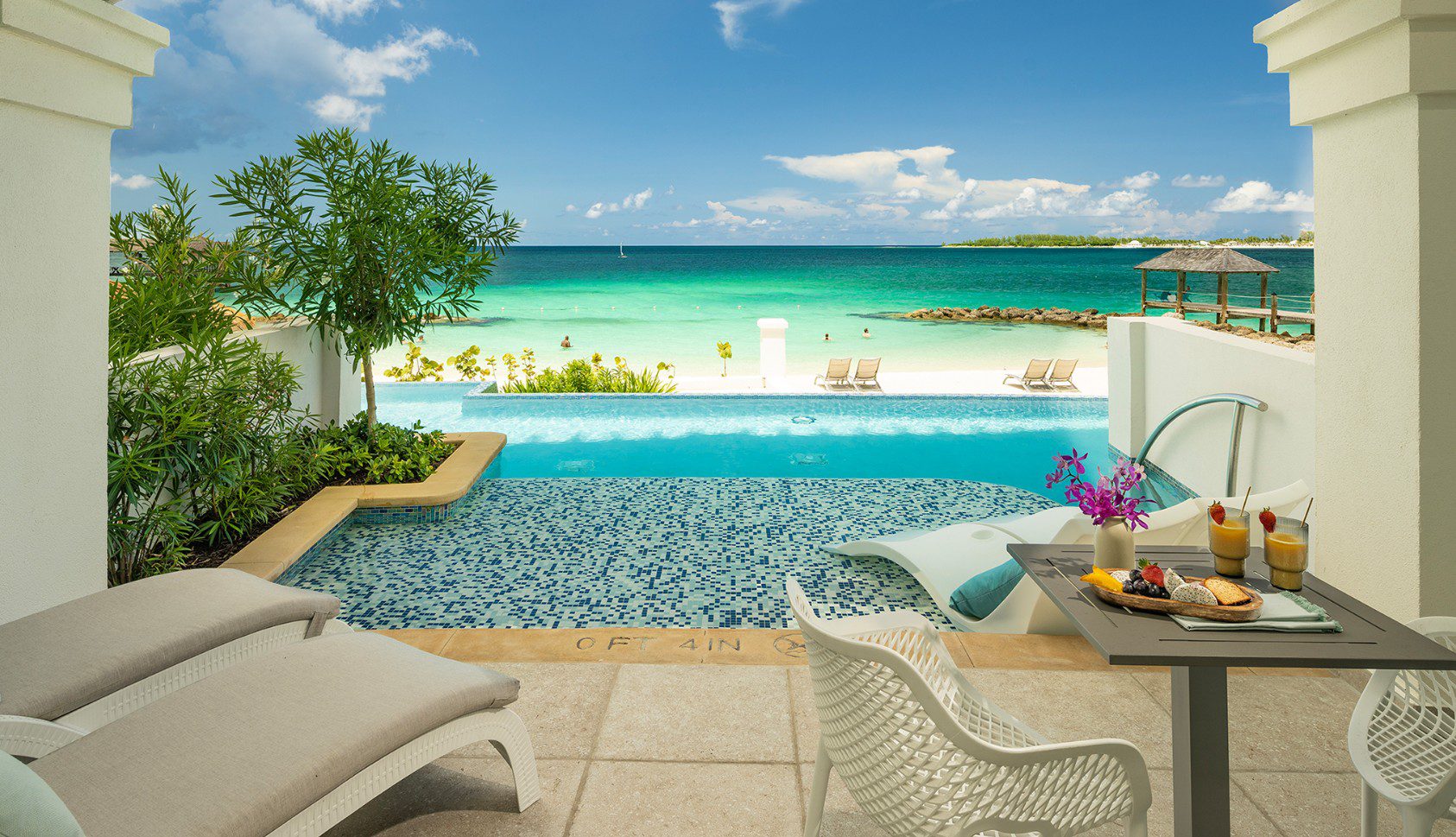 A pool with chairs and tables in the middle of it