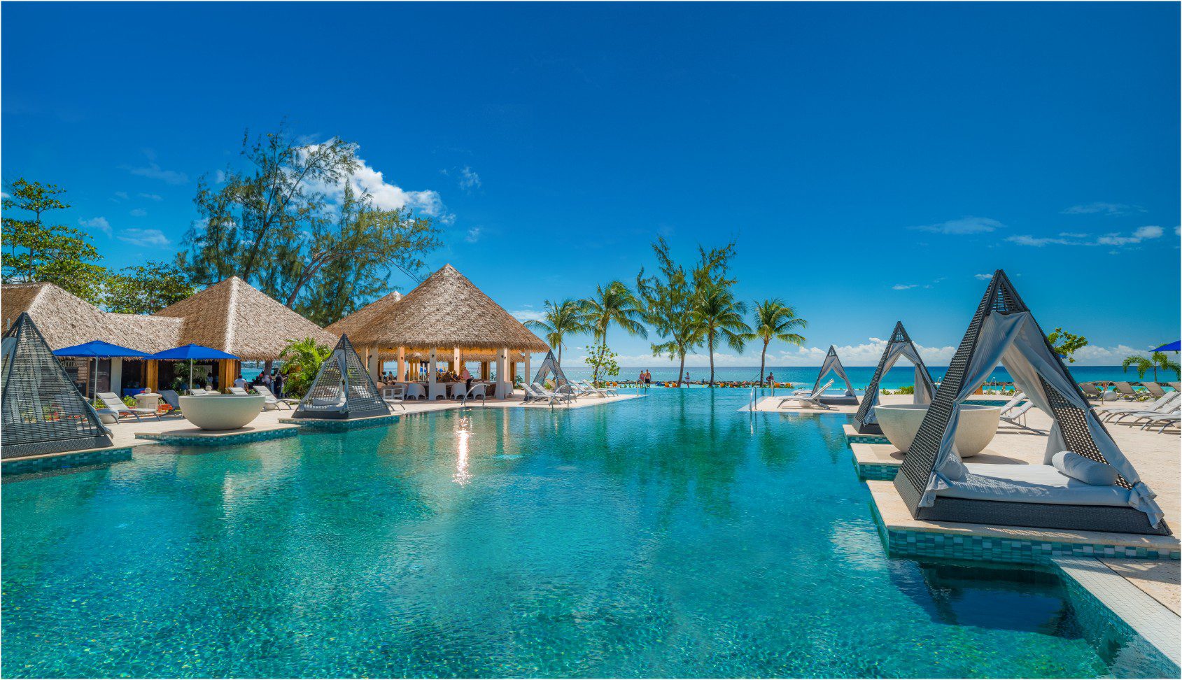 A pool with an umbrella and some chairs