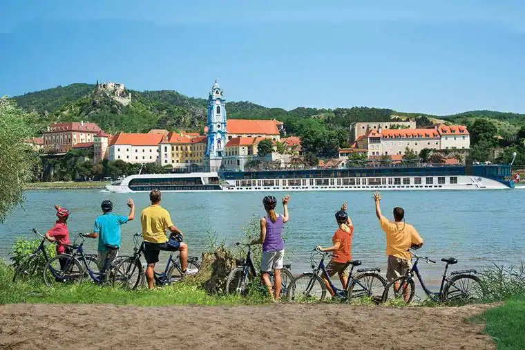 A group of people riding bikes on the beach.